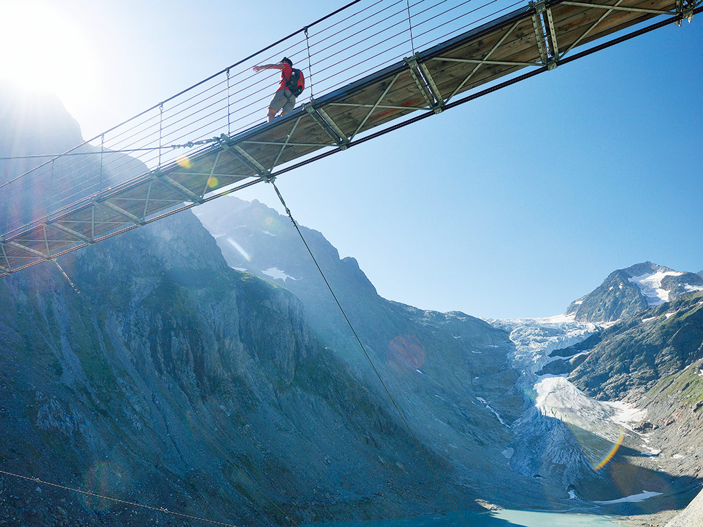 Man crossing a bridge in Switzerland