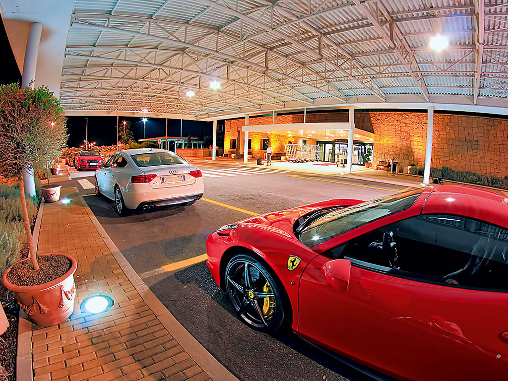 Ferrari and Audi parked outside Eccelsa Aviation's private terminal at Sardegna Olbia Costa Smeralda Airport