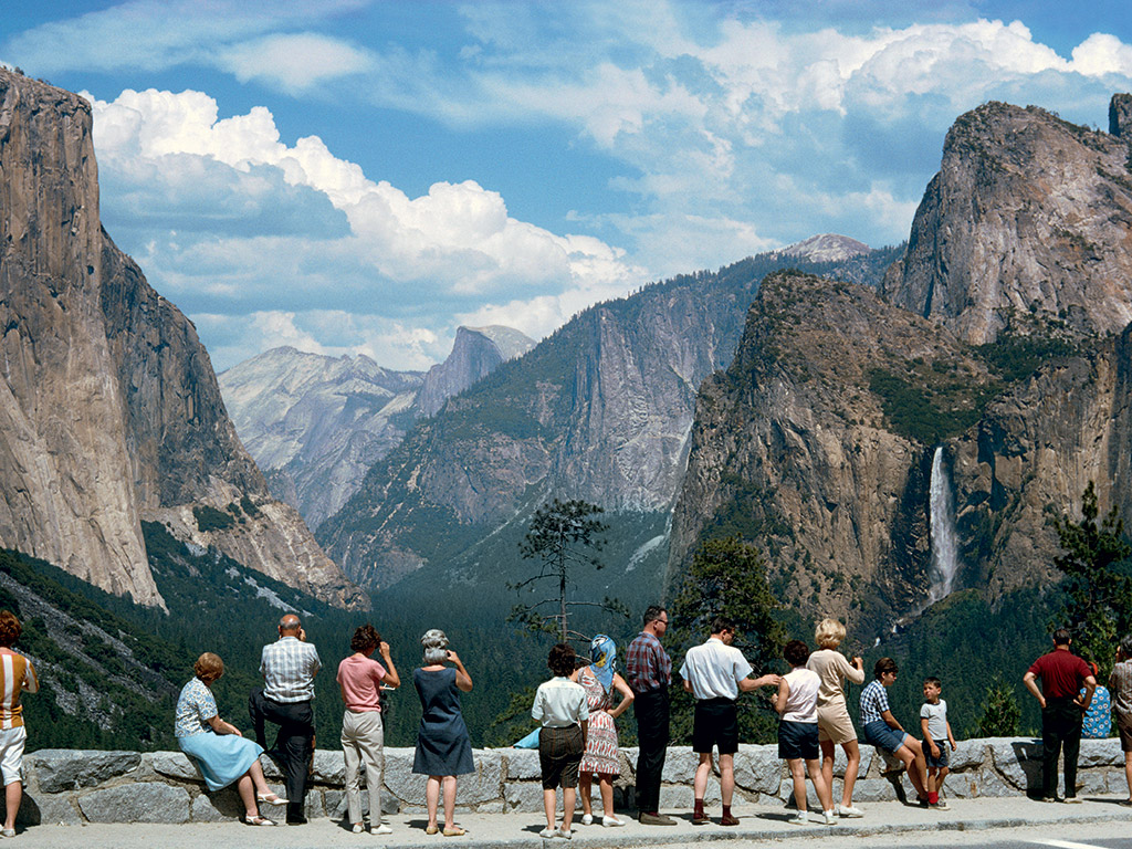 California, 1965 by B. Anthony Stewart. Tourists stretch their legs and take in the wonders of the Yosemite Valley