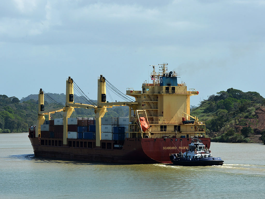 A cargo ship sails Corte Culebra in Gatun lake at the Panama Canal