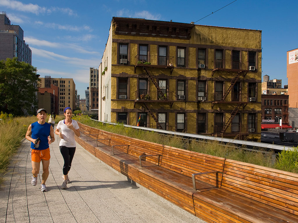 A couple jogs along High Line Park, making the most of inner-city public space away from busy roads 