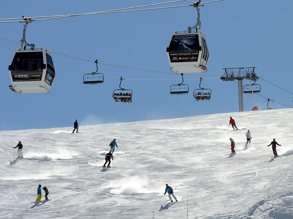 People ski on a Meribel piste in the French Alps. The ski resort is set in the Tarentaise Valley, near the town of Moutiers