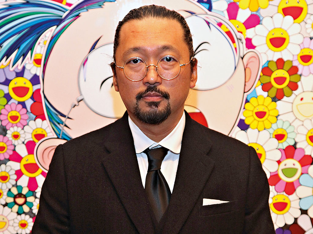 Artist Takashi Murakami poses in front of New day: Face of the Artist