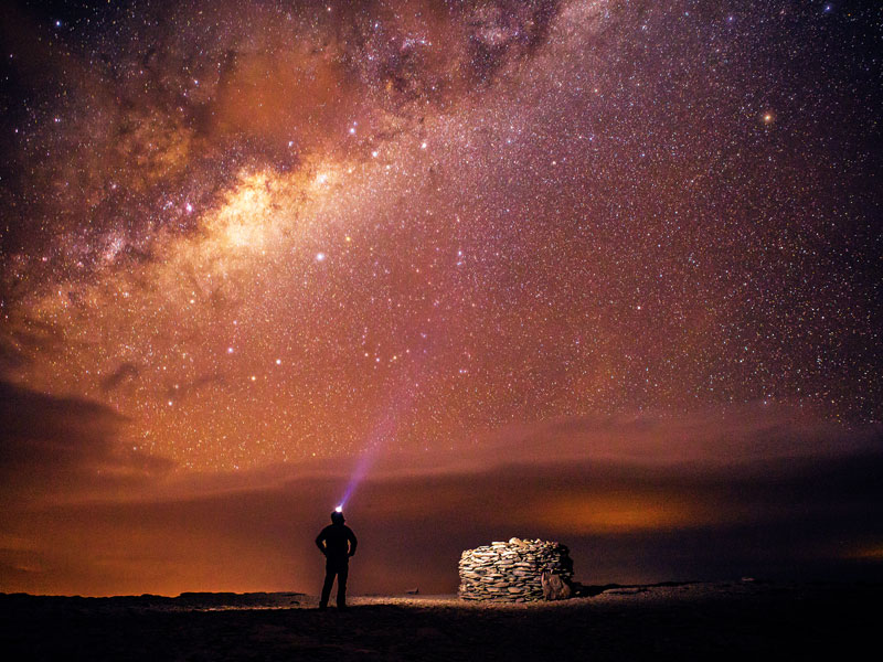 A traveller stands under the Milky Way in the Atacama Desert, Northern Chile