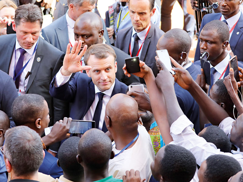 Emmanuel Macron leaving the University of Ouagadougou