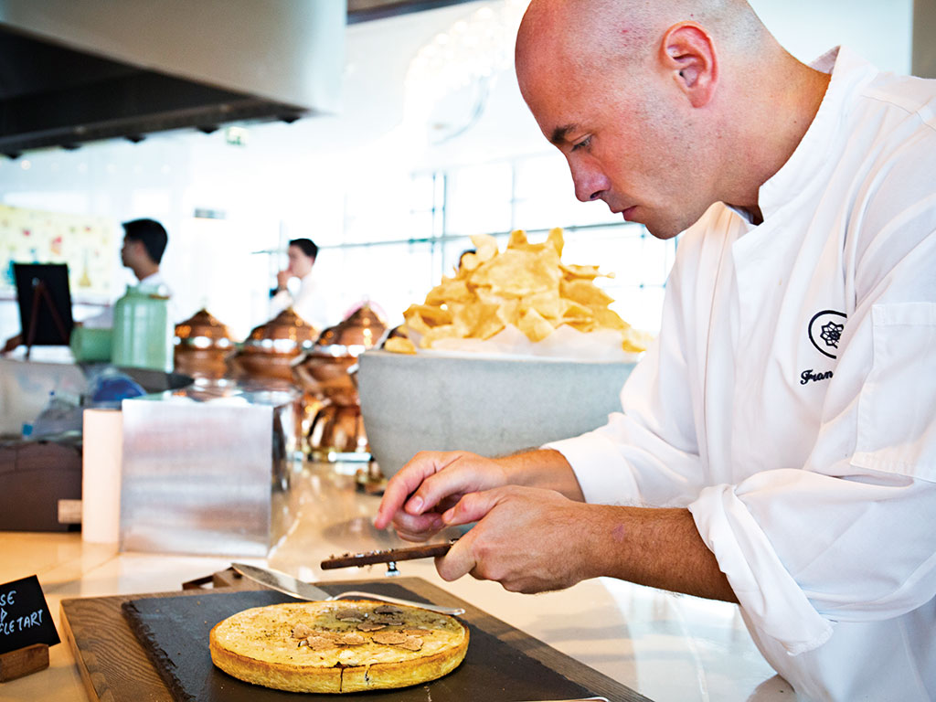A chef prepares food at Rosewood Abu Dhabi. The hotel has several restaurants to choose from